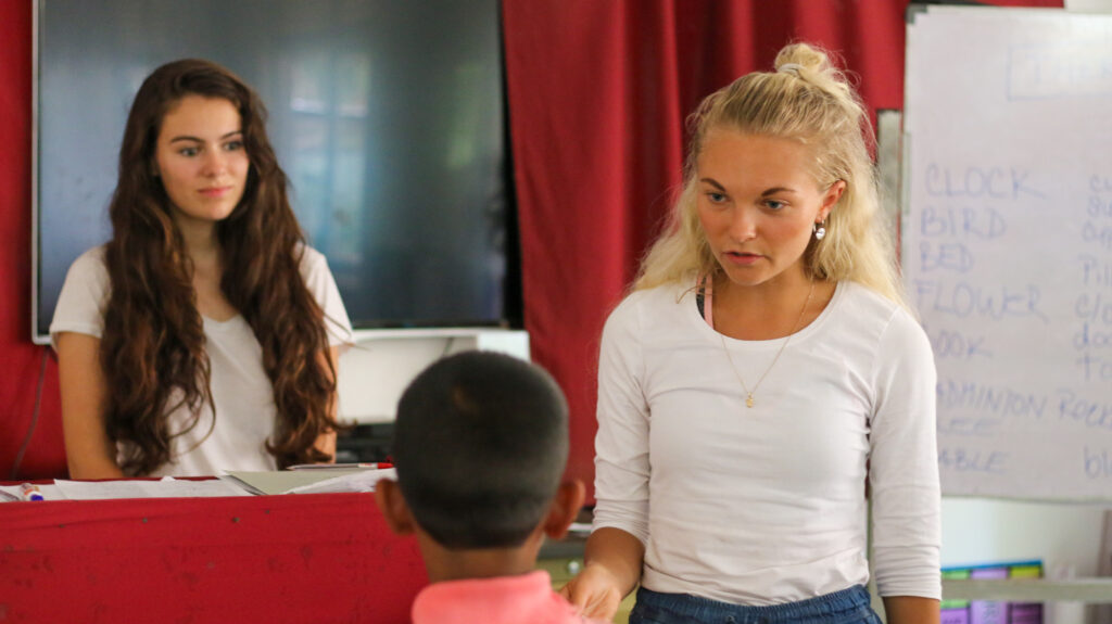 Two foreign volunteers leading a class