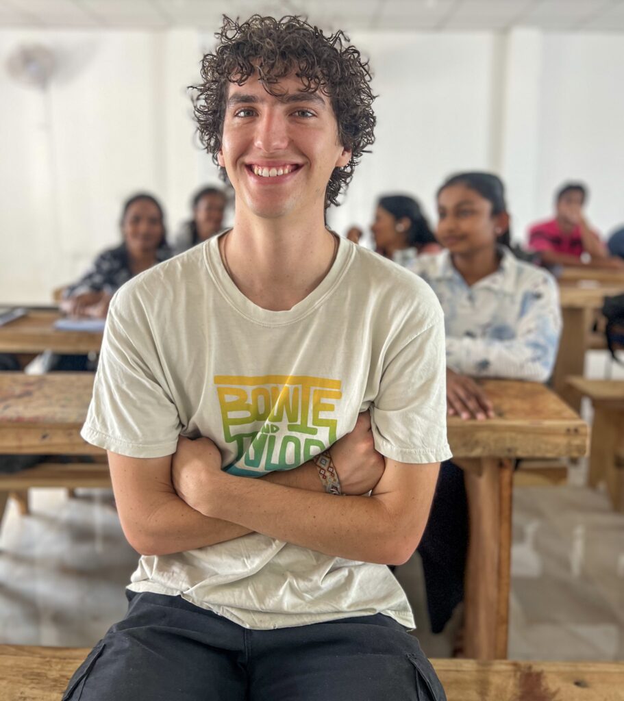 A volunteer smiling at the front of the class